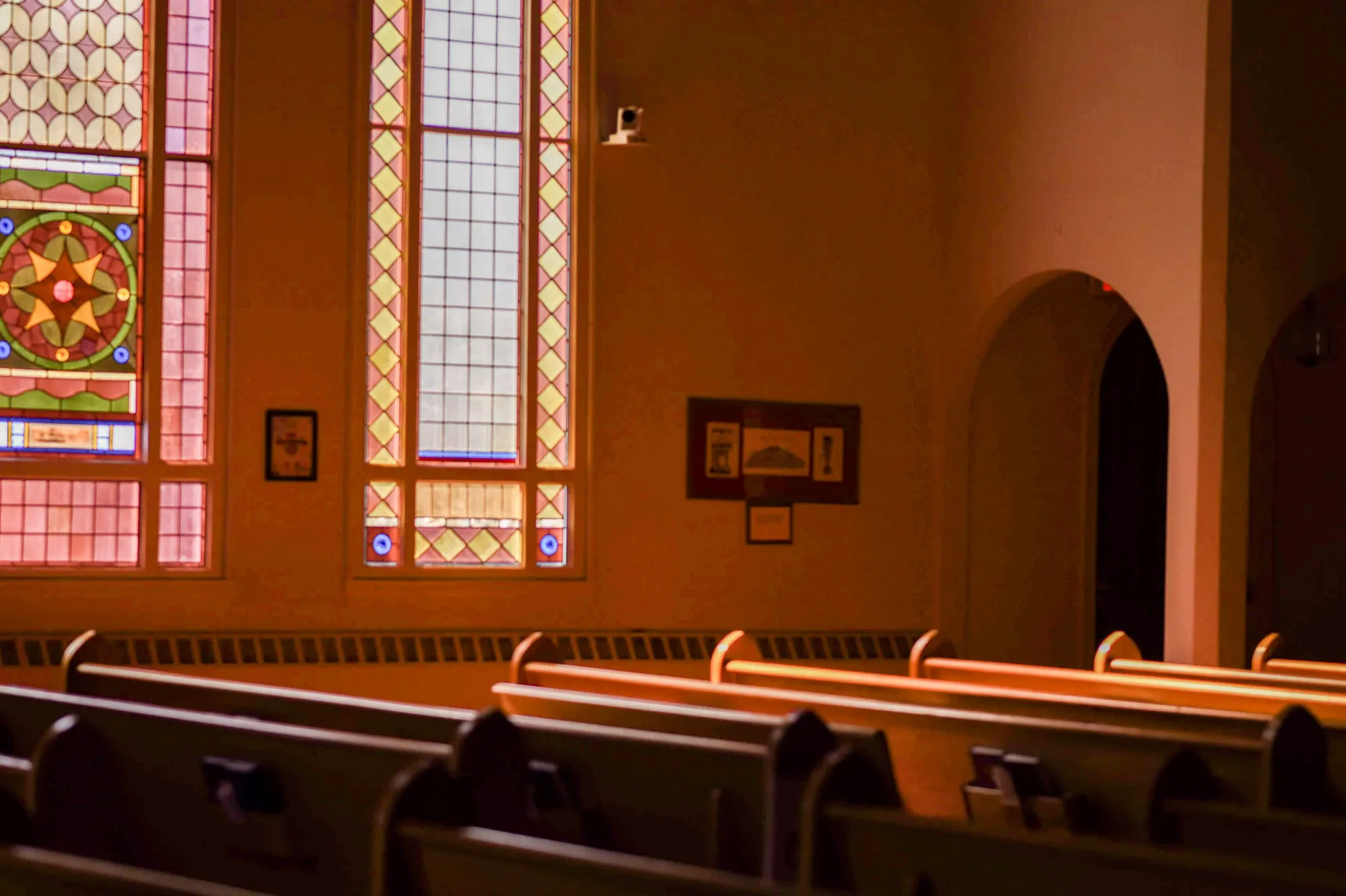 Sunlight streaming through MCC's stained glass windows