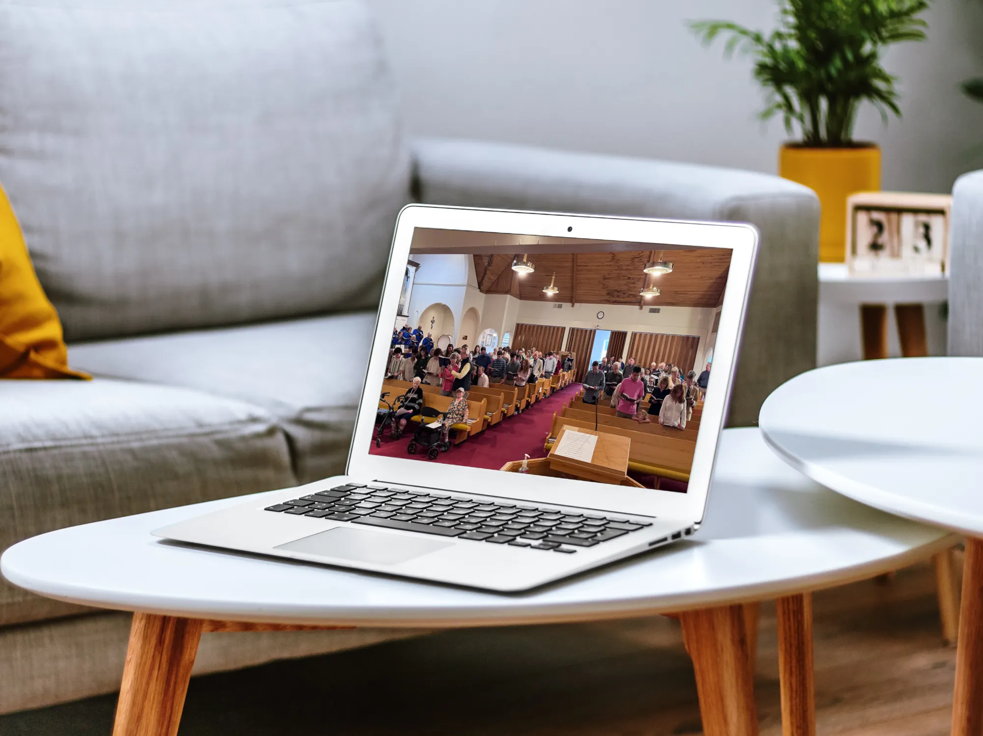 Laptop playing MCC's online worship service